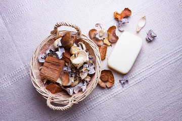 SUPERIOR VIEW OF BASKET WITH DRY FLOWERS AND NATURAL RUSTIC FABRIC