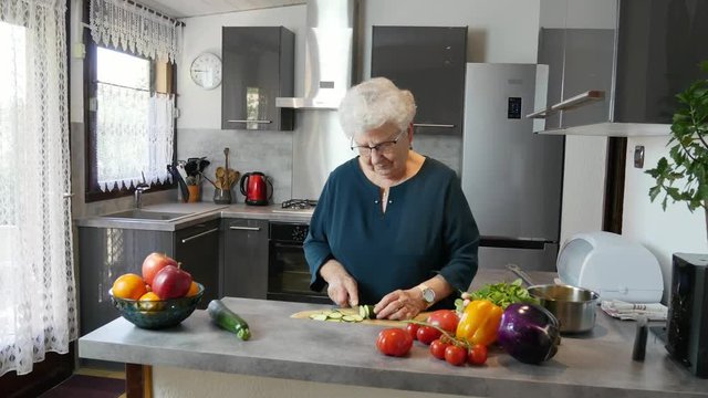 happy senior active woman cooking at home in a modern kitchen