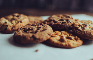 Tasty chocolate chip cookies as background, top view