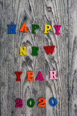 2020 Happy New year text for greeting card on wooden background, calendar, invitation