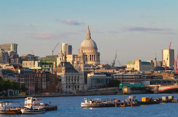 Naklejka premium The dome of St. Pauls Cathedral across the Thames river by the early evening sun, London.