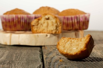 homemade muffins with coconut chips on a wooden stand