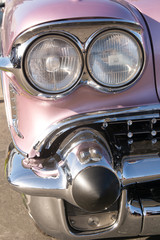 Obraz na płótnie Canvas head lights and grill on classic car. Car part art is specifically cropped to create interesting designs from classic American cars 04/06/2019