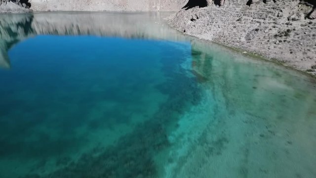  Rotate to adjacent shallow lake. Band-e Amir Lakes. Band-e Amir National Park, Bamyan Province, Afghanistan. Aerial. Birds eye view. Flyover. Rotation.