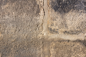The texture of the old wall of paved worn stone
