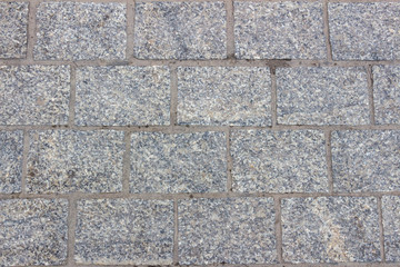 Texture of polished gray granite paving slabs
