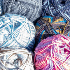 Close-up of colourful balls of wool on the sales stand of a flea market