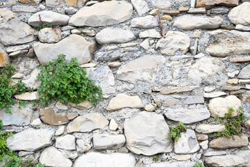 Detail view of an ancient stone wall in the village of Borgo Cervo in liguria Italy. Useful as a...