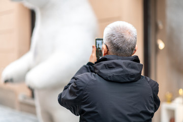 Old Asian Male tourist takes photos whilst sightseeing in Prague, Czech Republic - Easter Holidays April 2019Old Asian Male tourist takes photos whilst sightseeing in Prague, Czech Republic - Easter H