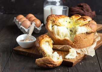 Freshly brioche bread with cottage cheese and raisin filling. Traditional Romanian sweet yeast bread. Easter bread. Rustic style. 