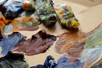 Oil paints and tubes on cardboard.