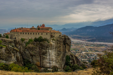 Fototapeta na wymiar highland monastery medieval religion church castle building on top of steep rock dramatic scenic Greece landscape