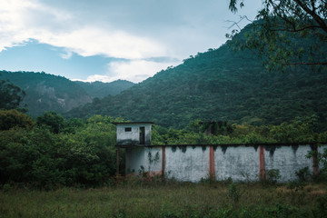 Fototapeta na wymiar Abandoned Prison in front of the Jungle