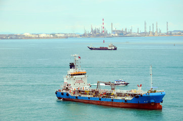Tanker ship ready to supply fuel to the cargo ship, Singapore industrial areas.