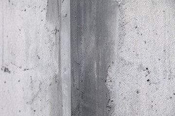 Texture background. Gray concrete wall with rough seams, mortar, plaster, abrasions, irregularities. Concept construction of country house, cottage, garage