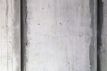 Texture background. Gray concrete wall with rough seams, mortar, plaster, abrasions, irregularities. Concept construction of country house, cottage, garage