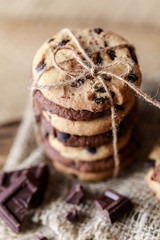 Chocolate cookies on wooden rustic table. Homemade cookies. Stack of tasty chocolate cookies