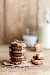 Chocolate cookies on wooden rustic table. Homemade cookies. Stack of tasty chocolate cookies