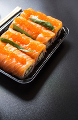 Philadelphia roll sushi with salmon, avocado, cream cheese.