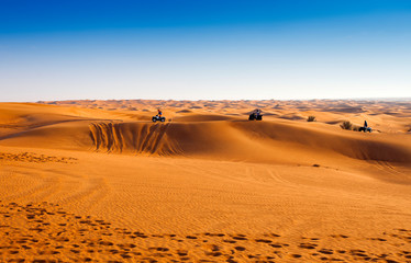 Fototapeta na wymiar desert safari experience with atv 4x4 vehicles