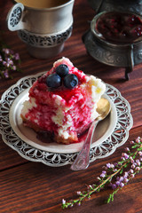 Piece of cake with jam and blue berries