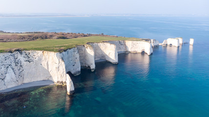 An aerial view of the Old Harry Rocks along the Jurassic coast with crystal clear water and white...