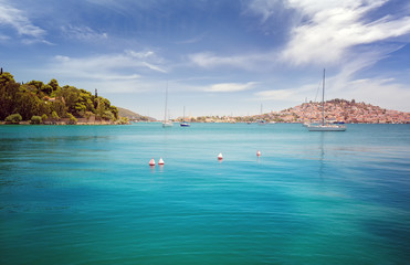 Fototapeta na wymiar Panoramic view from the sea of Poros island in Aegean sea, Greece. Crystal clear turquoise water