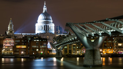London (UK). Night view of St.Paul's Cathedral and the Millennium Bridge from the South Bank. Landscape format.