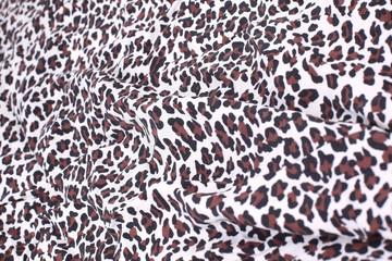 abstract background composed of leopard print fabric.