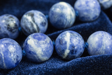 string of blue and white beads on blue velvet