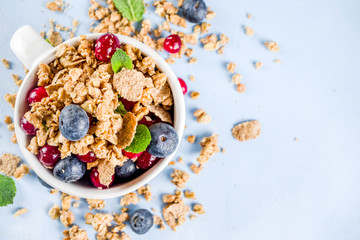 Small cup with breakfast granola, nuts and berries