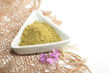 henna powder for dyeing hair and eyebrows and drawing mehendi on hands,  with green palm leaf