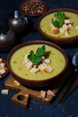 broccoli cream soup with croutons, vertical