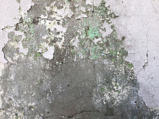 Old dirty grey concrete wall with cracked and peeling paint texture background.