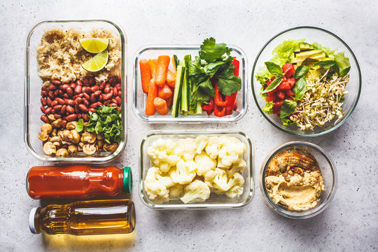 Healthy Vegan Food In Glass Containers, Top View. Rice, Beans, Vegetables, Hummus And Juice.