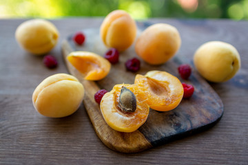 Fresh raspberry and Apricot on wooden cutting board. Fresh ripe fruits