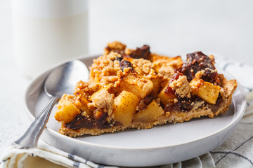 Piece of vegan apple pie with cinnamon, white background. Vegan food concept.