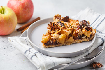 Piece of vegan apple pie with cinnamon, white background. Vegan food concept.
