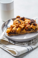 Piece of vegan apple pie with cinnamon and dates. Vegan food concept.