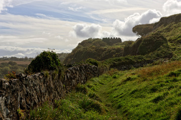 Ancient fortress wall and watchtower in a landscape. Northern Ireland, Downhill Beach, Coleraine