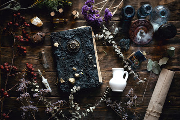 Magic recipe book and a magic potions on a table. Witchcraft background with copy space. Druid or...