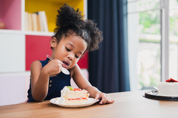 african girl kid eating sweet cake