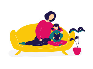 Mother reading books with daughter on sofa