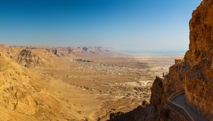 Panoramic view of the valley surrounding Masada and its cliffside walkways