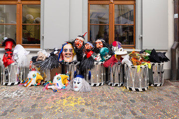 Augustinergasse, Basel, Switzerland - March 12th, 2019. Carnival masks and snare drums piled up in...