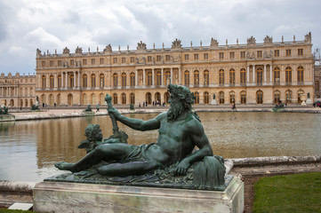 Fototapeta na wymiar Statue of The Rhone and Palace of Versailles on the background, Versailles, France