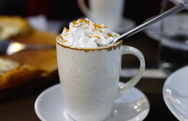 Cup of fresh caramel latte with whipped cream