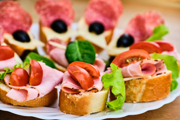 Small sandwiches with ham and salami