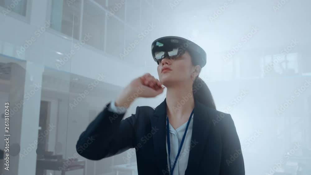 Poster Confident Female Engineer Using Augmented Reality Headset and Moving Virtual Pieces in the Air. In Innovation High Tech Laboratory Facility with Futuristic Atmosphere.