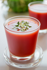 Red tomato juice in a glass, bright morning sun, healthy breakfast